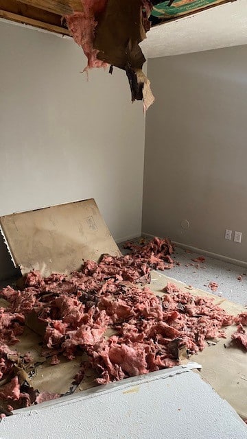 Drywall ceiling caved in with wet insulation about the room, cleaned up by a restoration company in Worthington, Ohio