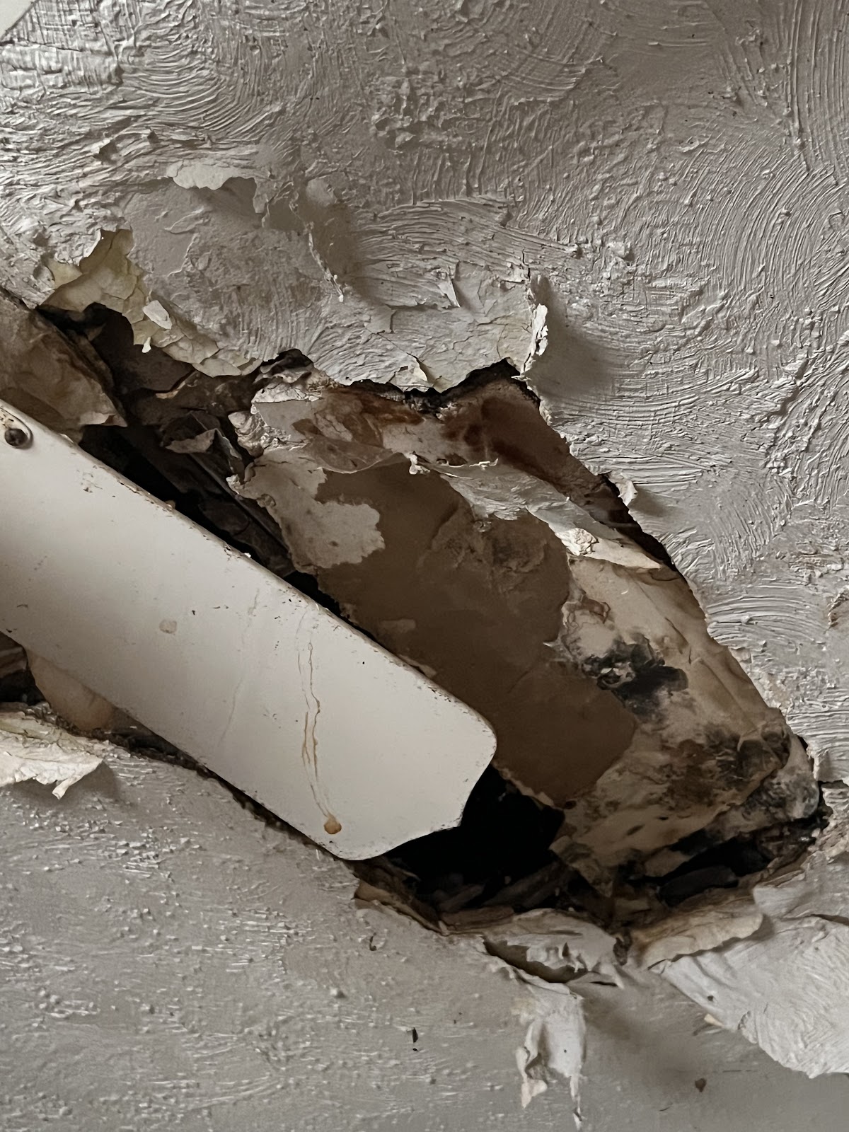 Severe wall and ceiling drywall water damage exposing framing and insulation in a Columbus, Ohio home